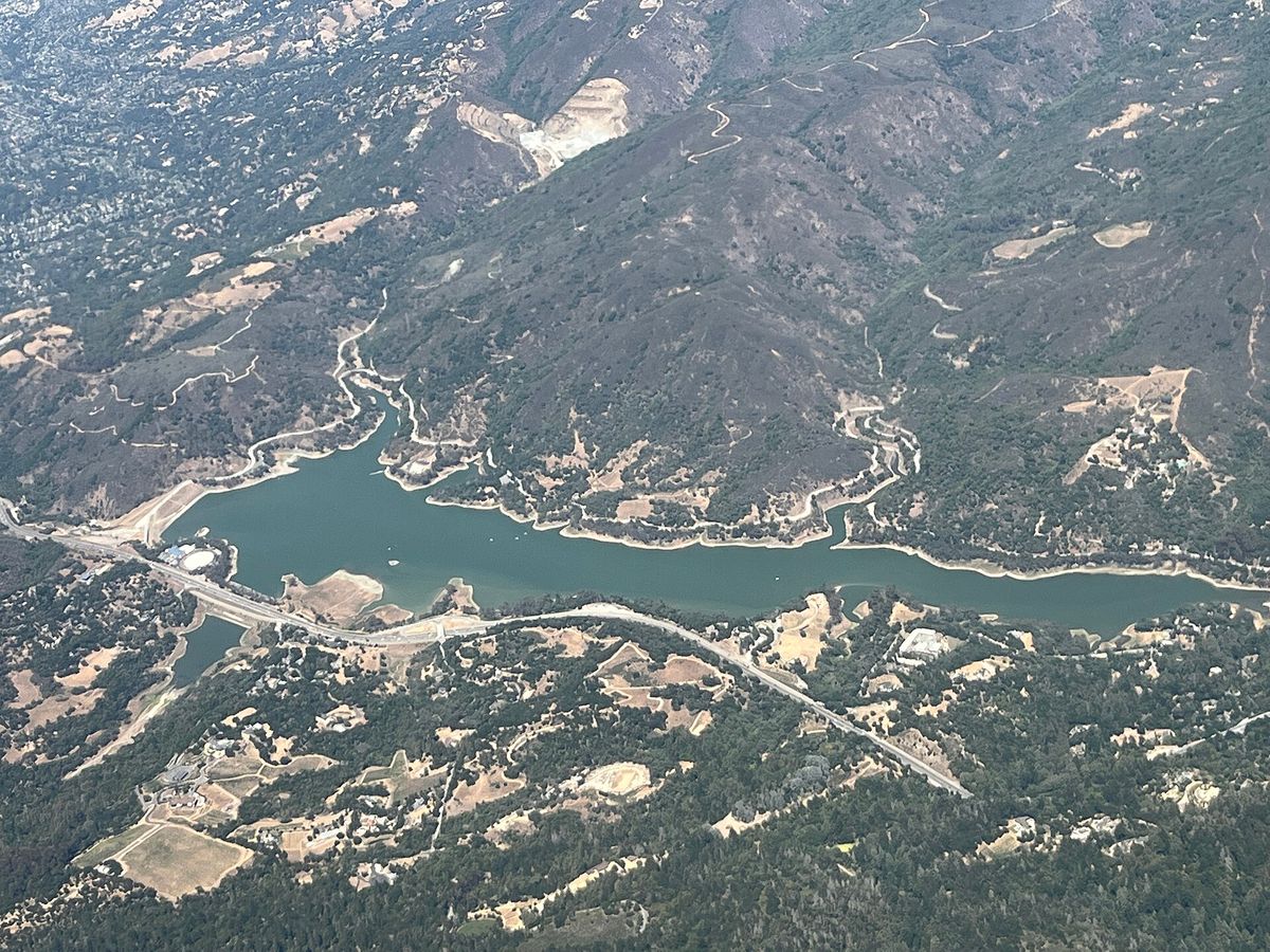 Lexington Reservoir from the air, winding between the mountains