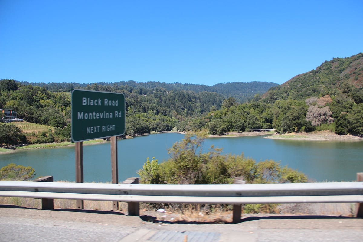 Lexington Reservoir and its wooded hills, seen from beside Highway 17