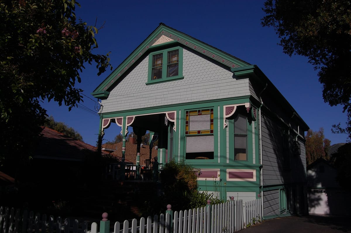 A small gabled cottage with green trim on Edelen Avenue