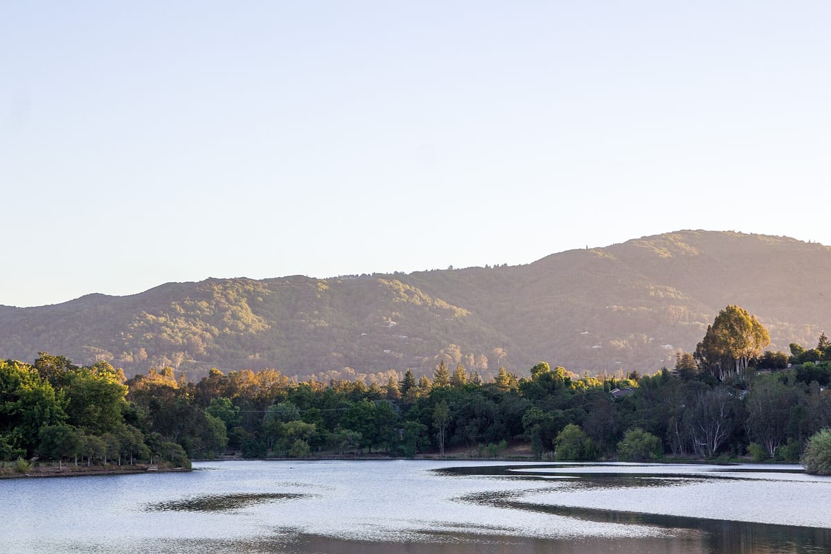 Vasona Reservoir at dusk with the foothills beyond